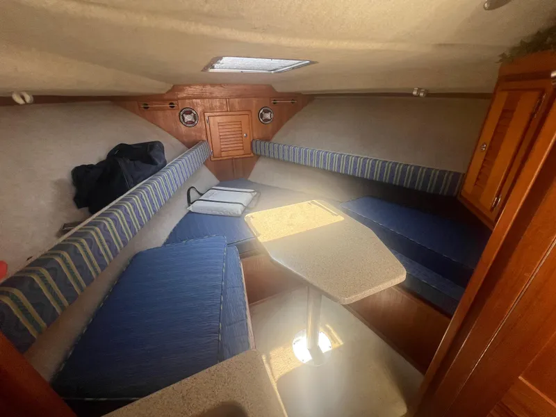Slide: The Image of 2003 Albemarle 268 Express Fisherman cabin interior with seating and table. - 14