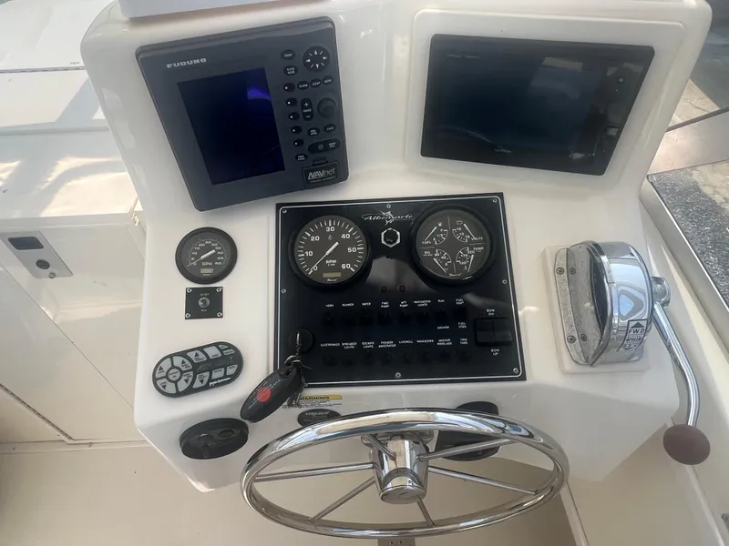 Slide: The Image of 2003 Albemarle 268 Express Fisherman helm with navigation instruments and steering wheel. - 15