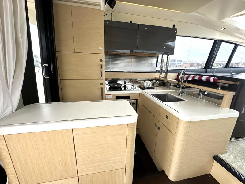 Slide: The Image of Modern kitchen interior on a 2017 Prestige 500 S yacht, featuring sleek cabinetry and appliances. - 13