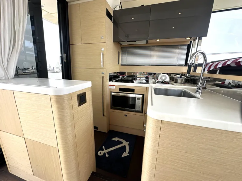 Slide: The Image of Modern kitchen interior of 2017 Prestige 500 S yacht with wood cabinetry and stainless steel appliances. - 14