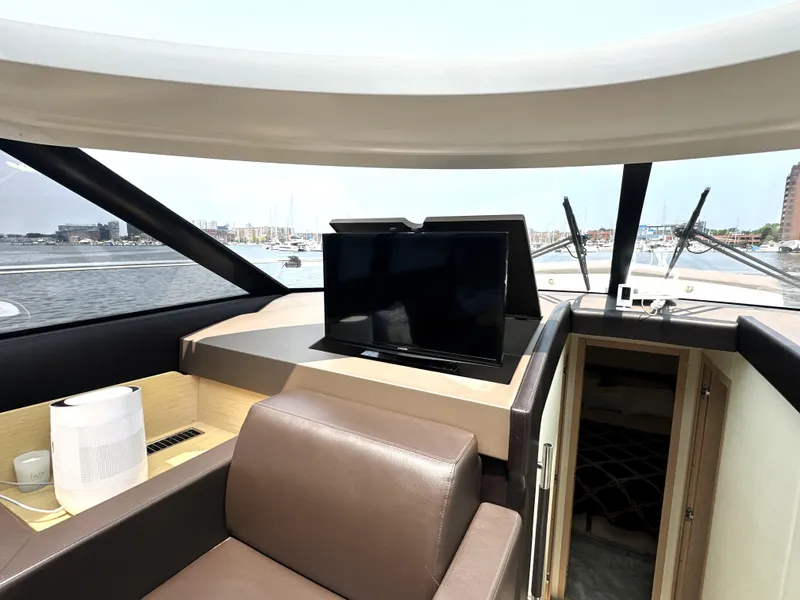 Slide: The Image of Luxurious interior of 2017 Prestige 500 S yacht with TV and leather seating. - 21
