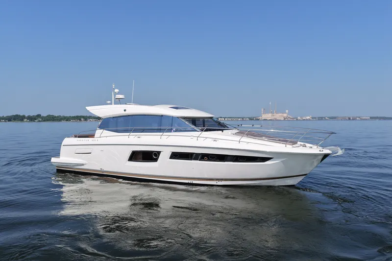 Slide: The Image of 2017 Prestige 500S yacht cruising on calm waters under a clear blue sky. - 4