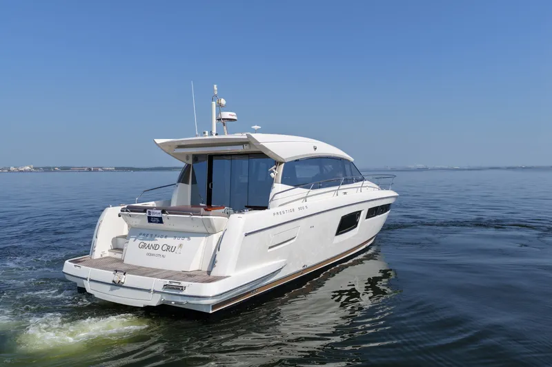 Slide: The Image of 2017 Prestige 500S yacht cruising on calm waters under clear blue skies. - 6