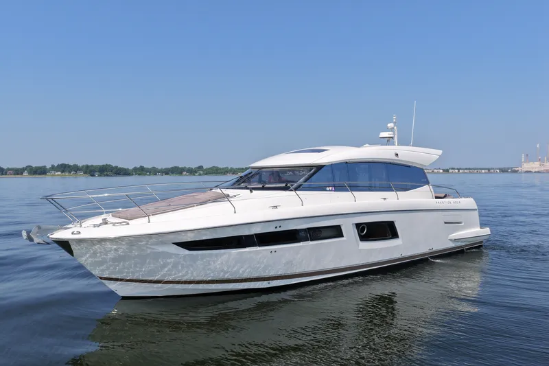 The Image of 2017 Prestige 500S yacht cruising on calm waters under clear blue skies. - 0