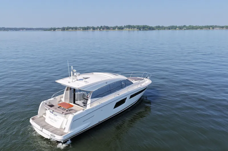 Slide: The Image of 2017 Prestige 500S yacht cruising on a calm lake under a clear blue sky. - 9