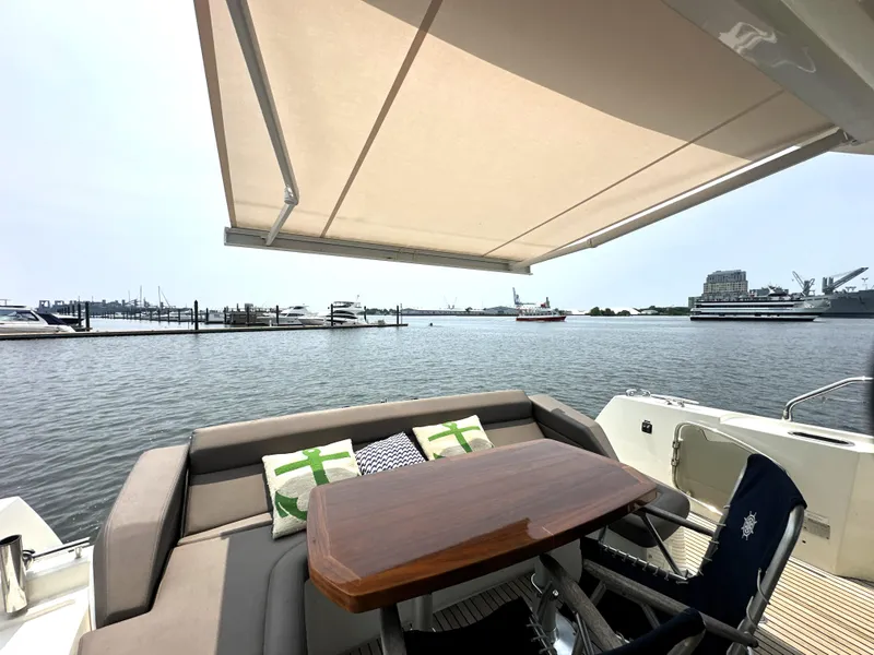 Slide: The Image of Luxury yacht deck with seating, table, and awning; Prestige 500 S, 2017 model. - 8