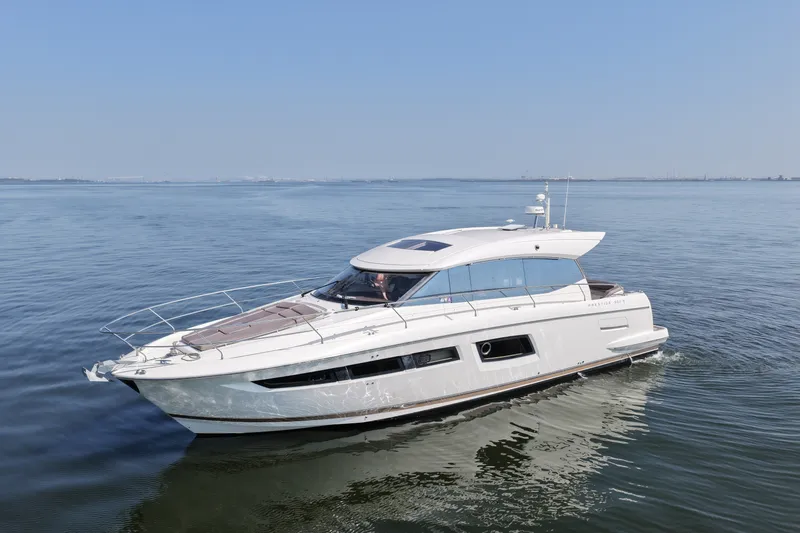 Slide: The Image of 2017 Prestige 500S yacht cruising on calm waters under a clear blue sky. - 12