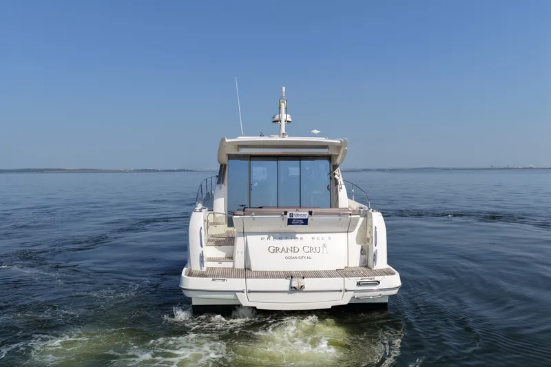 Slide: The Image of 2017 Prestige 500S yacht cruising on calm waters under clear blue skies. - 7