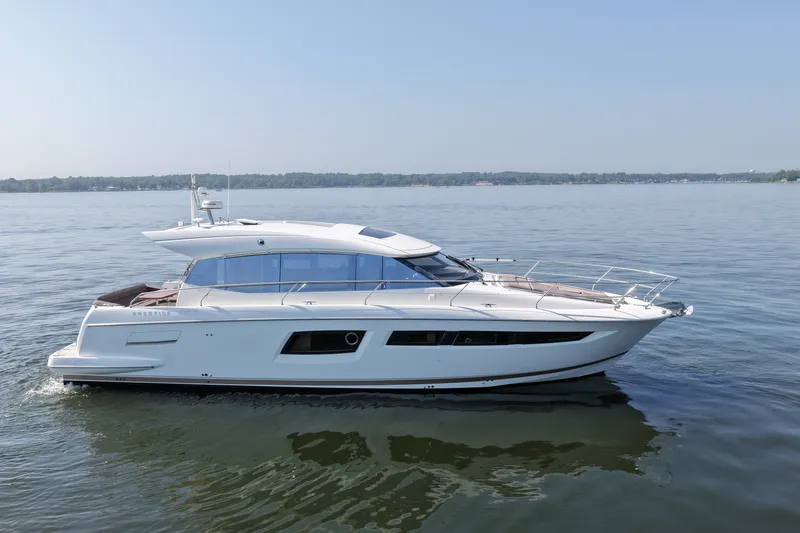 Slide: The Image of 2017 Prestige 500S yacht cruising on calm waters under a clear blue sky. - 8