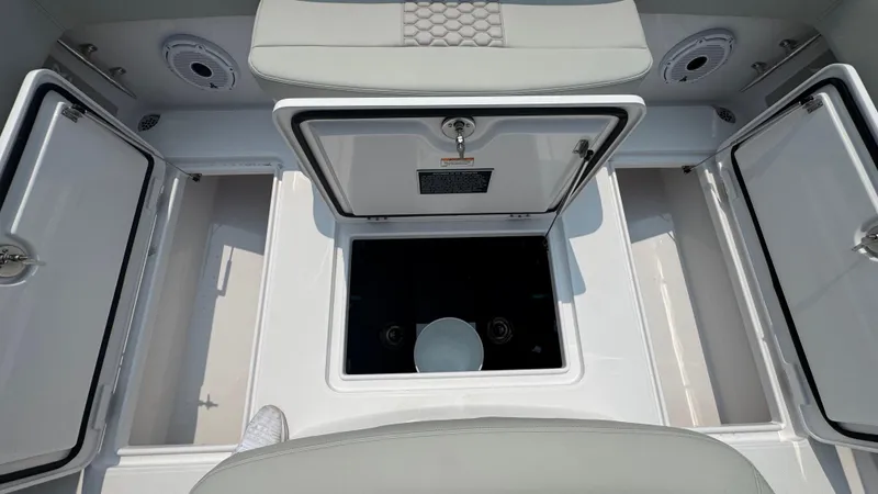 Slide: The Image of 2026 Jupiter 32 boat storage compartments with open hatches and seating. - 18