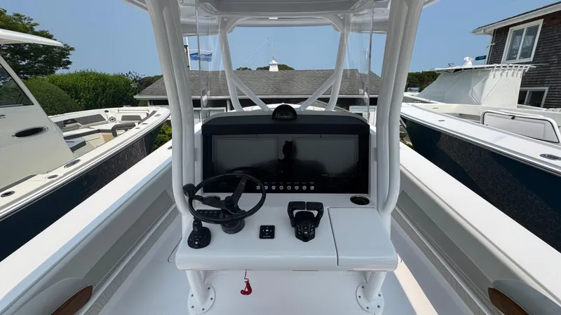 Slide: The Image of Center console of a 2026 Jupiter 32 boat with steering wheel and controls. - 21