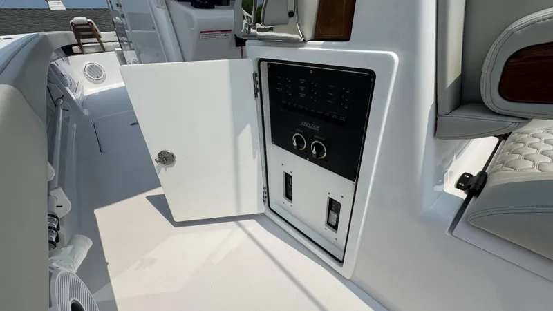 Slide: The Image of Control panel on a 2026 Jupiter 32 boat with open access door. - 25