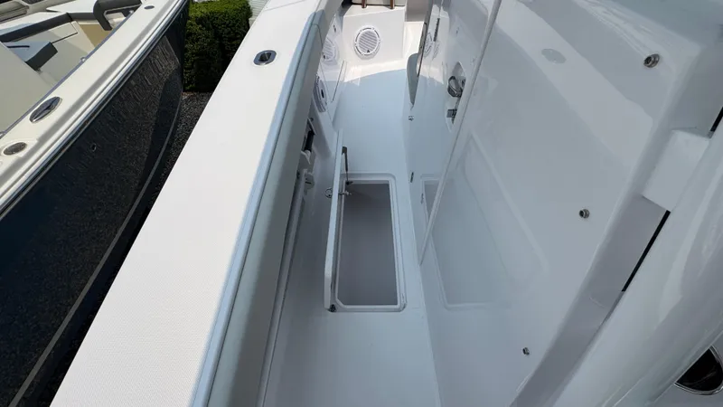 Slide: The Image of 2026 Jupiter 32 boat interior with sleek white deck and storage compartments. - 27