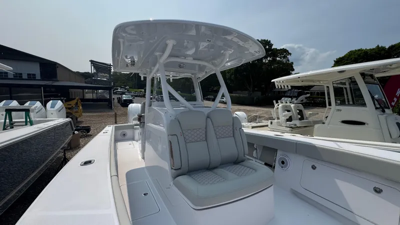 Slide: The Image of 2026 Jupiter 32 boat with sleek design and spacious seating, docked outdoors. - 30