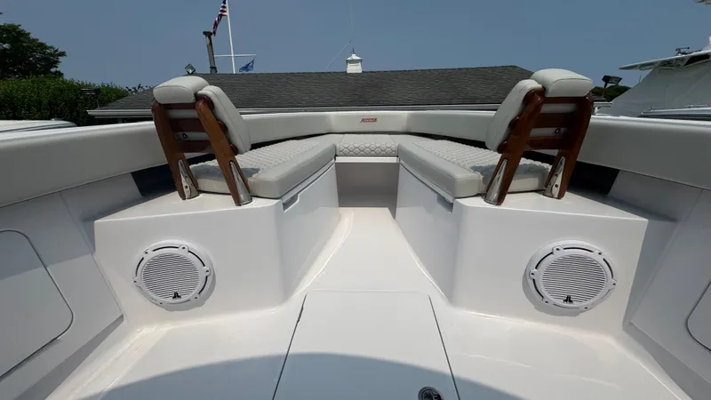 Slide: The Image of 2026 Jupiter 32 boat interior with cushioned seating and built-in speakers. - 34
