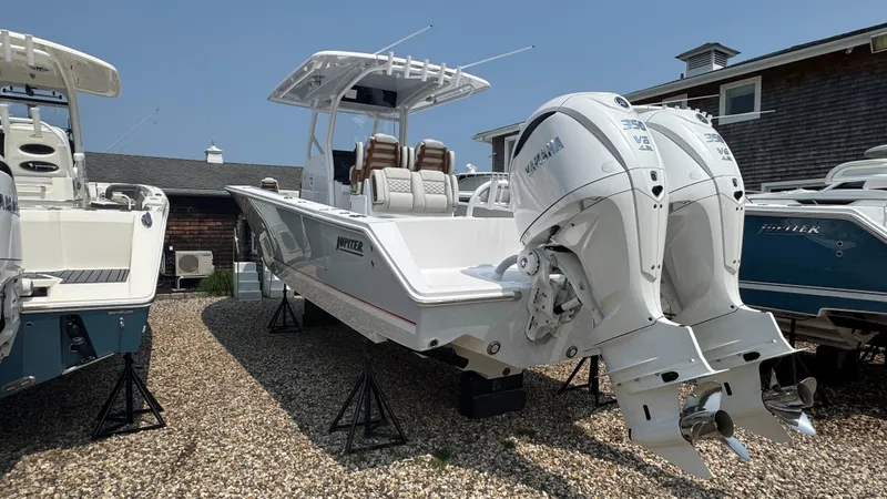 Slide: The Image of 2026 Jupiter 32 boat with dual engines on display in a marina setting. - 4