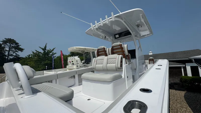 Slide: The Image of 2026 Jupiter 32 boat with sleek design and comfortable seating, docked outdoors. - 8