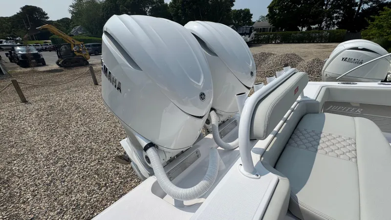 Slide: The Image of Twin Yamaha outboard engines on a 2026 Jupiter 32 boat, parked on gravel. - 9
