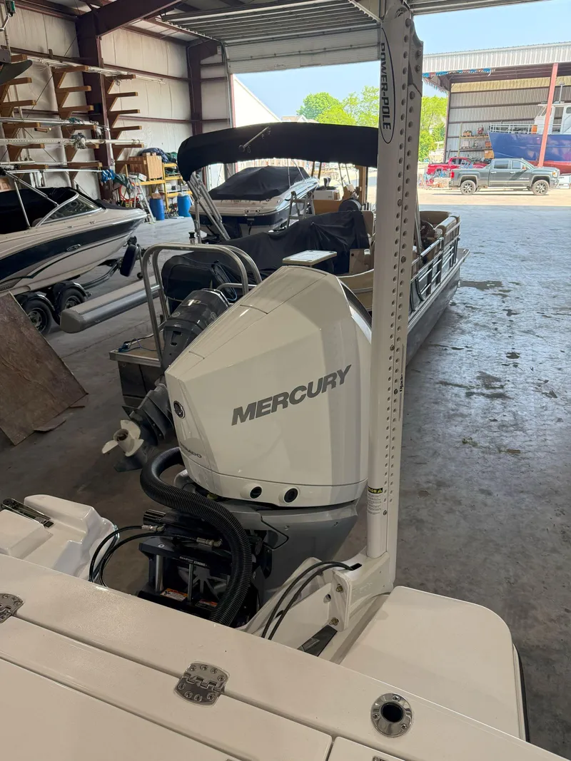 Slide: The Image of 2026 Blackfin 242HB boat with Mercury engine in a storage facility. - 11