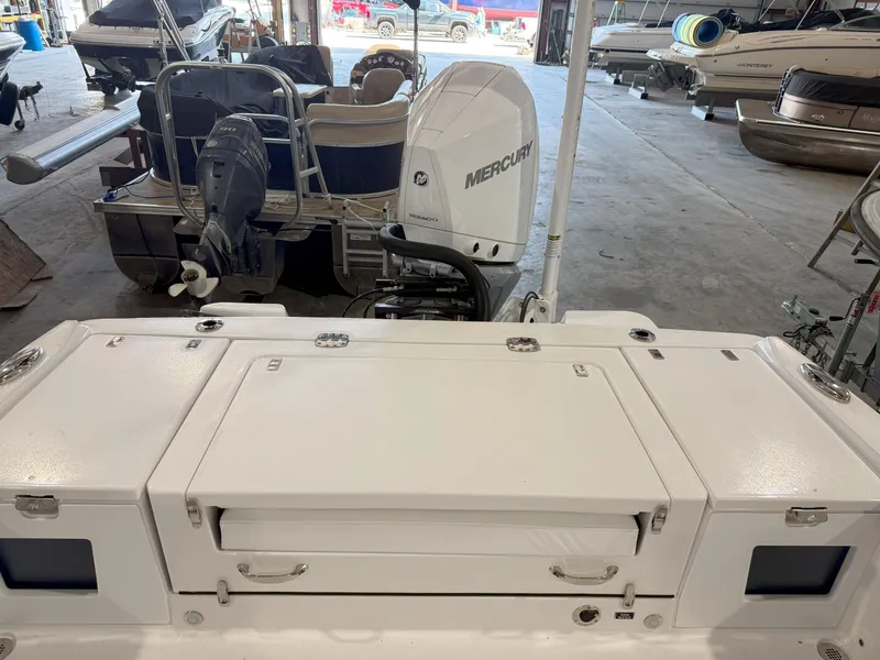 Slide: The Image of 2026 Blackfin 242HB boat with Mercury engine in a storage facility. - 12