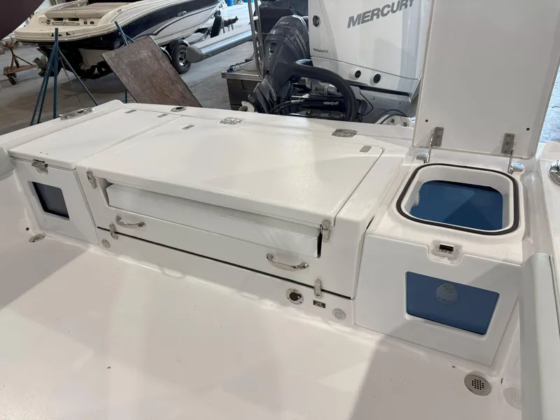 Slide: The Image of 2026 Blackfin 242HB boat interior with storage compartments and seating area. - 13