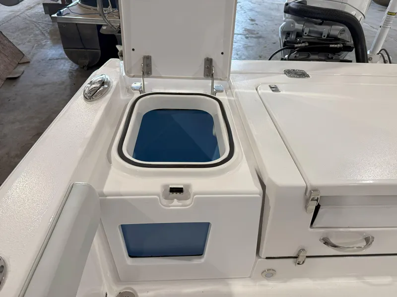 Slide: The Image of 2026 Blackfin 242HB boat with open storage compartment and sleek design. - 14