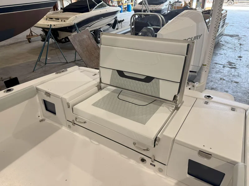 Slide: The Image of 2026 Blackfin 242HB boat interior with foldable seating and storage compartments. - 17