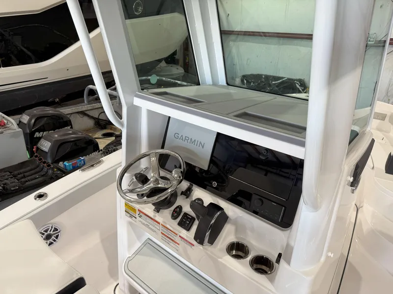 Slide: The Image of 2026 Blackfin 242HB boat console with Garmin navigation system and steering wheel. - 23