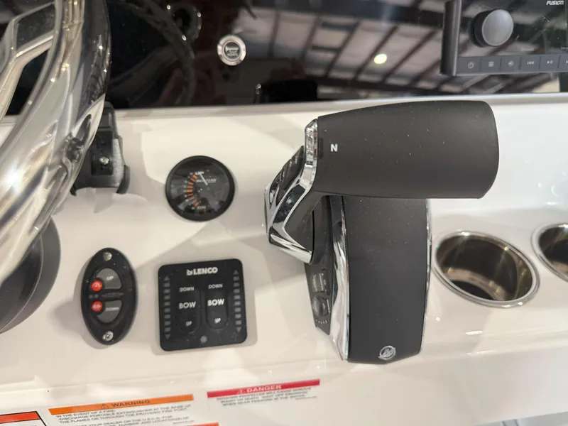 Slide: The Image of 2026 Blackfin 242HB boat control panel with throttle, gauges, and cup holders. - 25
