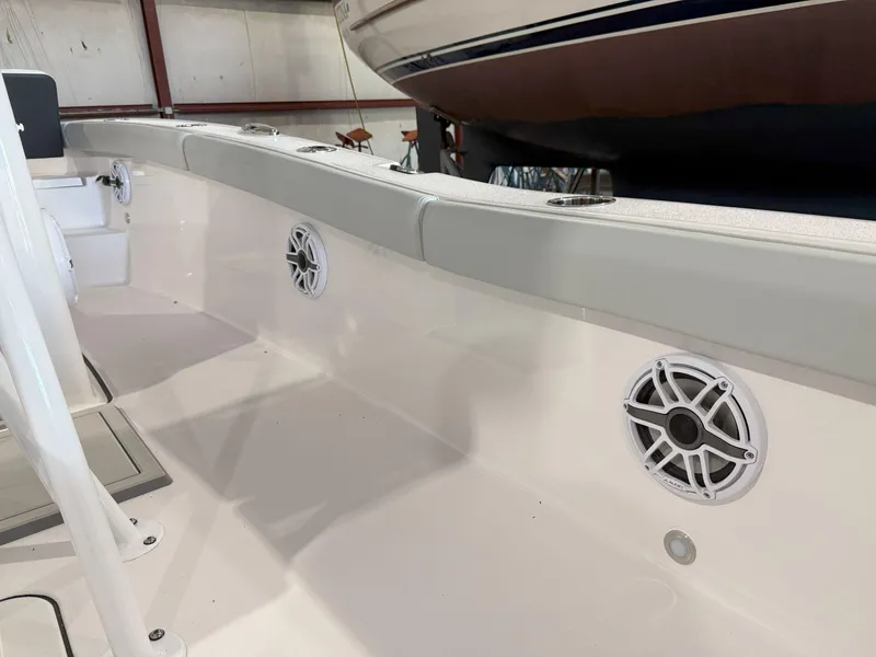 Slide: The Image of 2026 Blackfin 242HB boat interior with speakers and cushioned seating. - 26