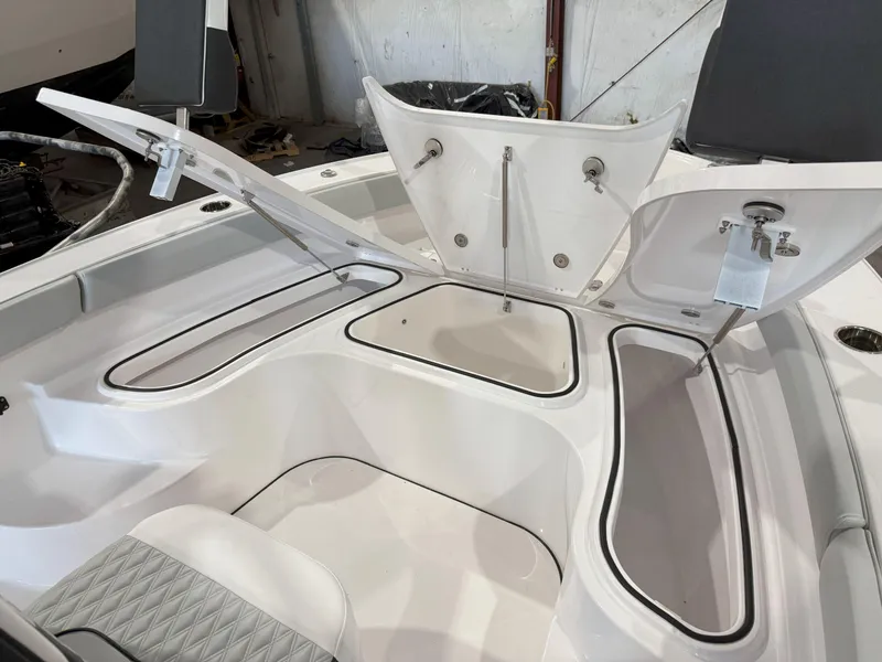 Slide: The Image of 2026 Blackfin 242HB boat with open storage compartments and seating area. - 28
