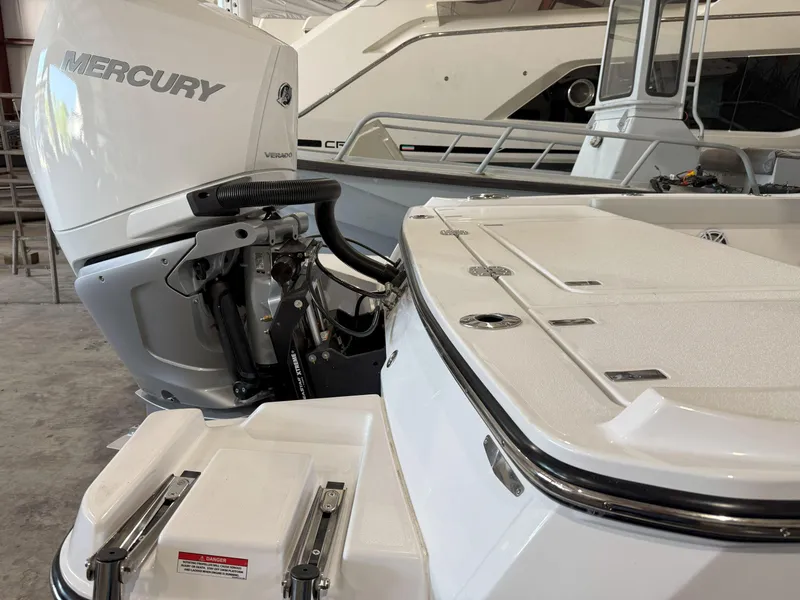 Slide: The Image of 2026 Blackfin 242HB boat with Mercury outboard engine in a marina setting. - 8