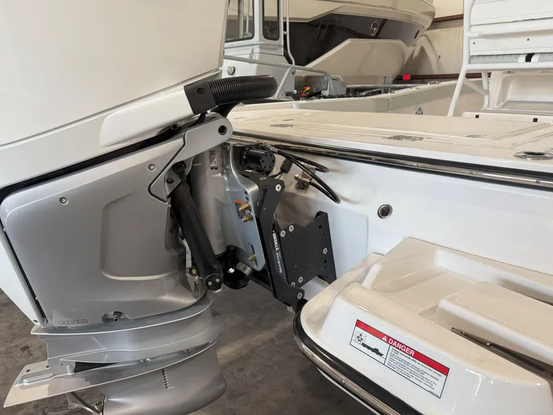 Slide: The Image of 2026 Blackfin 242HB boat engine detail in a showroom setting. - 9