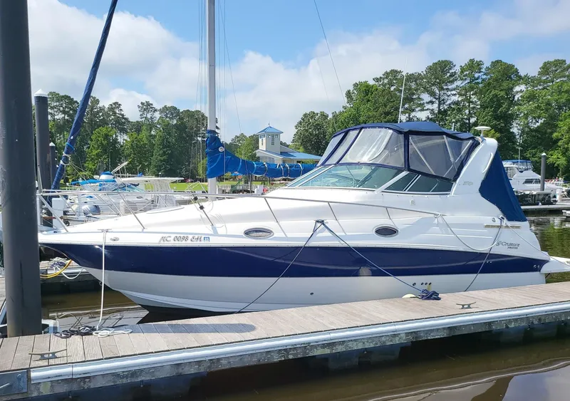 The Image of 2004 Cruisers 280CXi boat docked at a marina with trees in the background. - 0