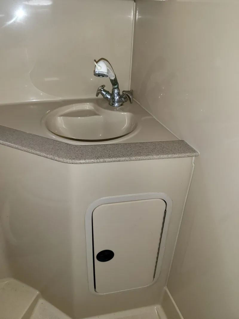 Slide: The Image of 2004 Cruisers 280CXi bathroom sink with faucet and storage compartment. - 10