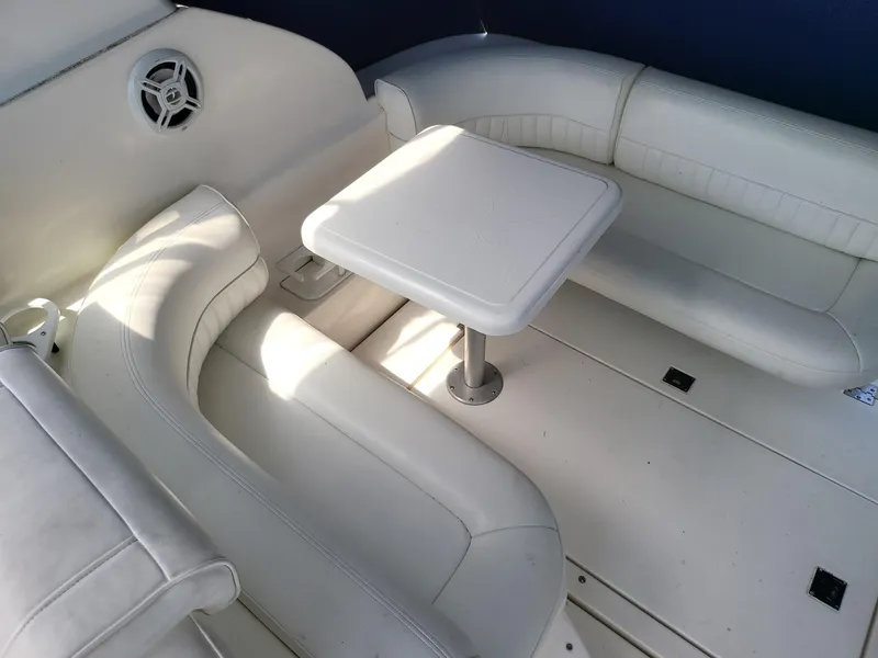 Slide: The Image of 2004 Cruisers 280CXi boat interior with white seating and table. - 12