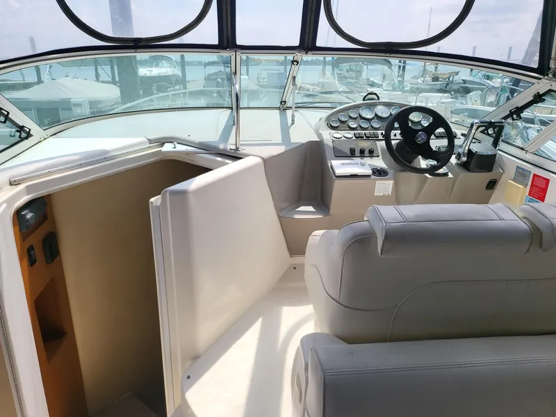 Slide: The Image of 2004 Cruisers 280CXi boat interior with helm, seating, and dashboard controls. - 13