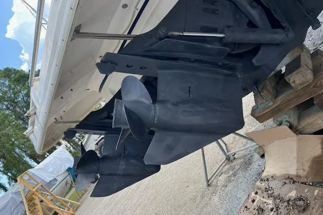 Slide: The Image of 2004 Cruisers 280CXi boat propellers on dry dock, showcasing dual outboard motors. - 20