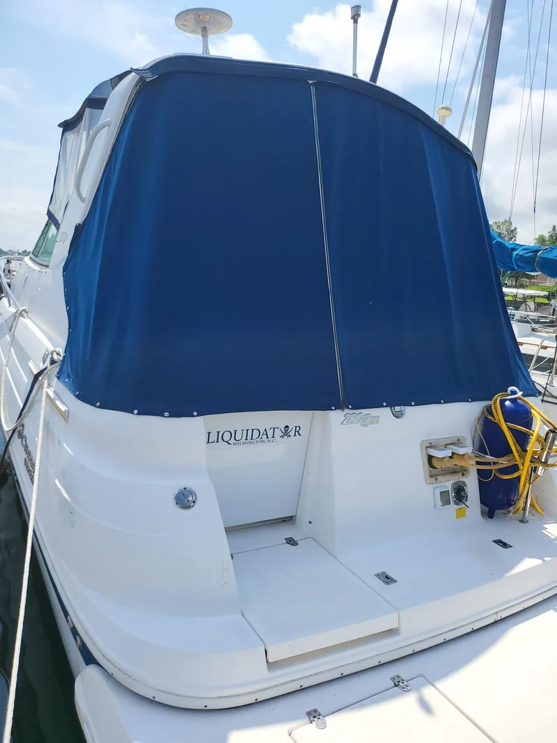 Slide: The Image of 2004 Cruisers 280CXi boat with blue canvas cover docked at marina. - 3