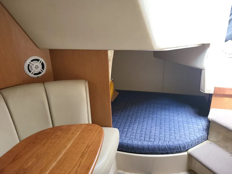 Slide: The Image of 2004 Cruisers 280CXi cabin interior with seating and bed. - 6