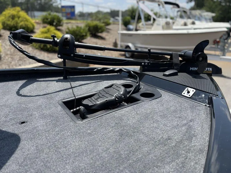 Slide: The Image of 2025 Tracker SAVAGE™ 215 boat deck with trolling motor and foot pedal controls. - 15