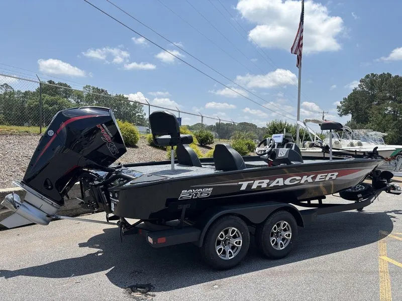 Slide: The Image of 2025 Tracker SAVAGE™ 215 boat on trailer, parked outdoors under a clear sky. - 17