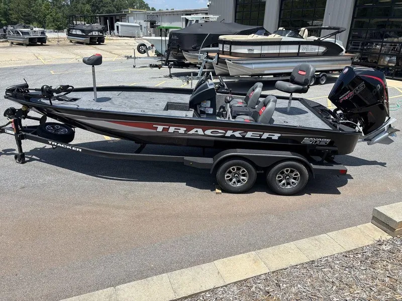 Slide: The Image of 2025 Tracker SAVAGE™ 215 boat on trailer, parked outdoors, side view. - 18