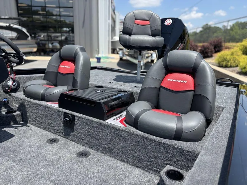Slide: The Image of 2025 Tracker SAVAGE™ 215 boat interior with gray and red cushioned seats. - 19