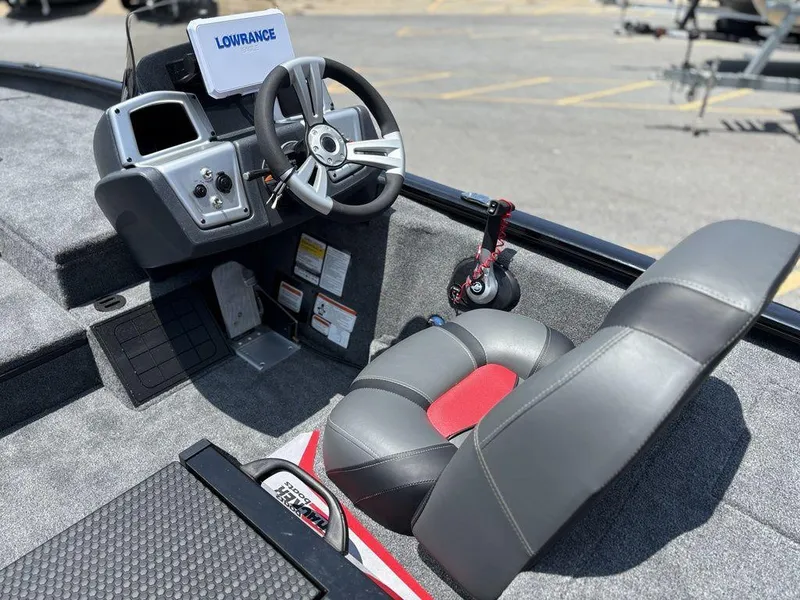 Slide: The Image of 2025 Tracker SAVAGE™ 215 boat cockpit with steering wheel and Lowrance navigation system. - 3