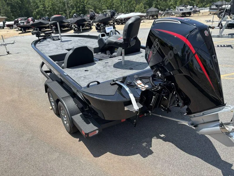 Slide: The Image of 2025 Tracker SAVAGE™ 215 boat with powerful outboard motor, parked on a trailer. - 7