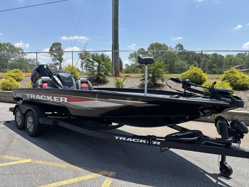Slide: The Image of 2025 Tracker SAVAGE™ 215 boat on trailer, parked outdoors under clear sky. - 9