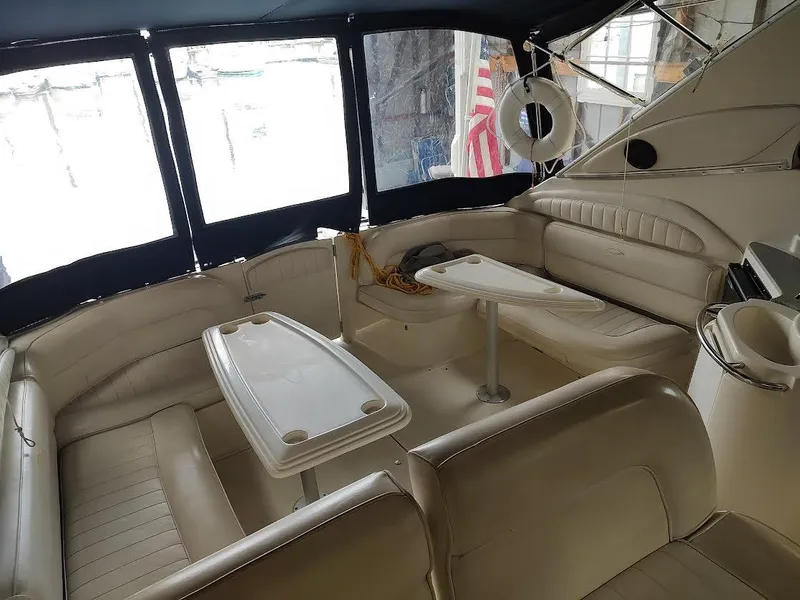 Slide: The Image of 1998 Maxum 4100 Sun Bridge SCR yacht interior with seating and tables. - 10