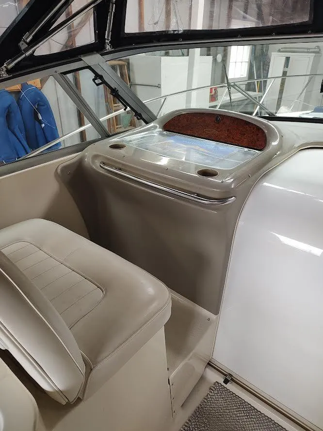 Slide: The Image of 1998 Maxum 4100 Sun Bridge SCR boat interior with beige seating and dashboard. - 13
