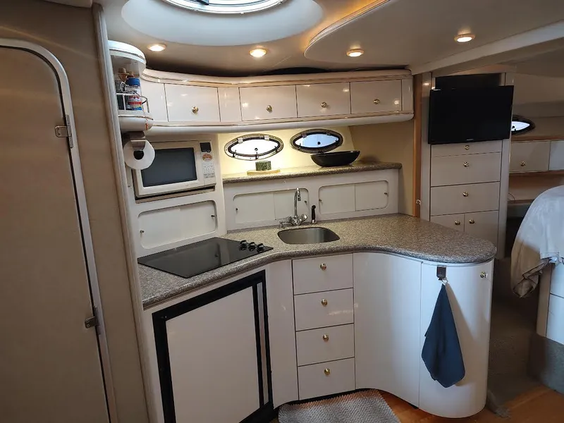 Slide: The Image of Luxurious 1998 Maxum 4100 Sun Bridge SCR yacht interior kitchen with modern amenities. - 17